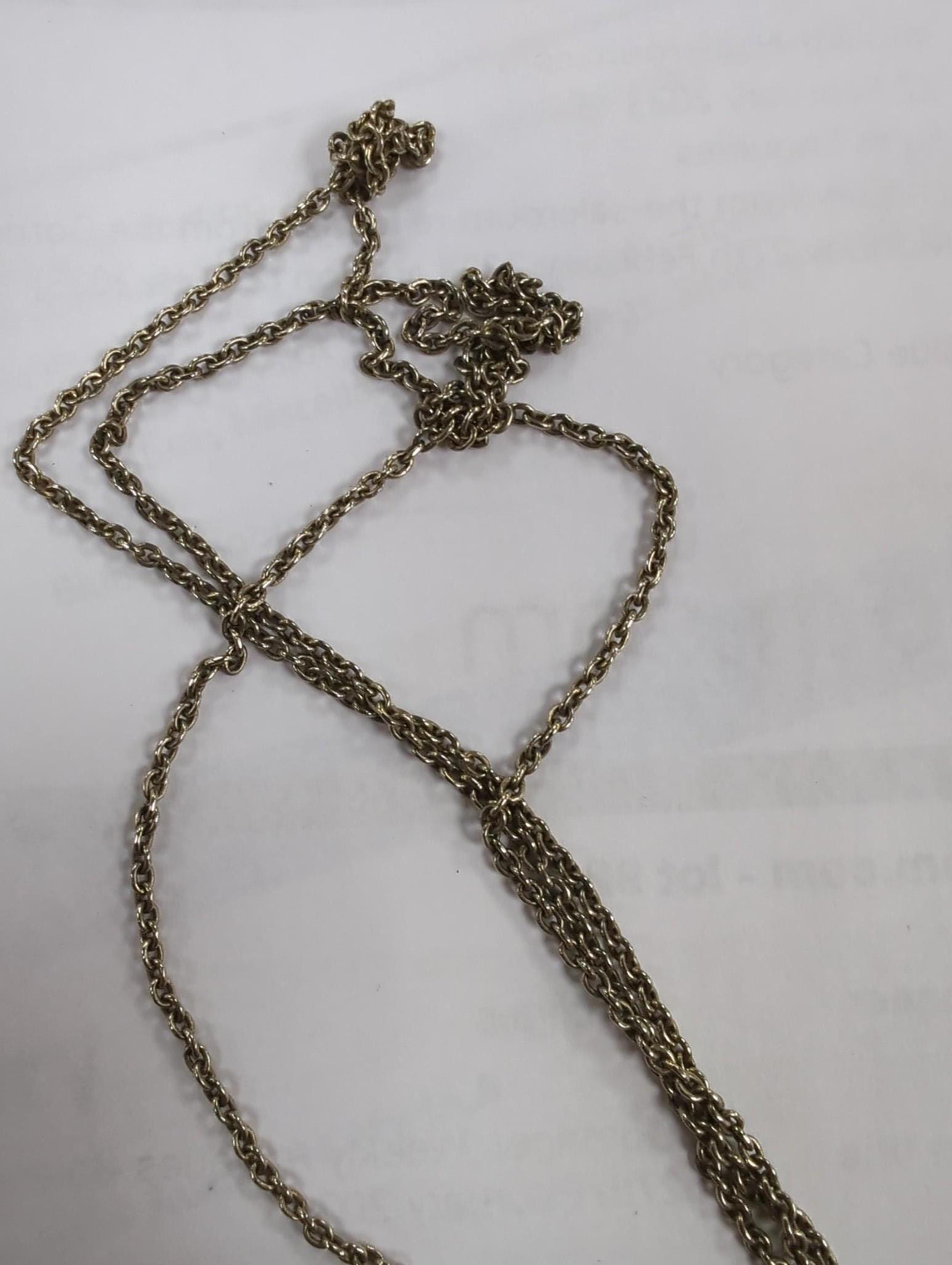 Two carved jade pendants, largest 47mm on a white metal chain.